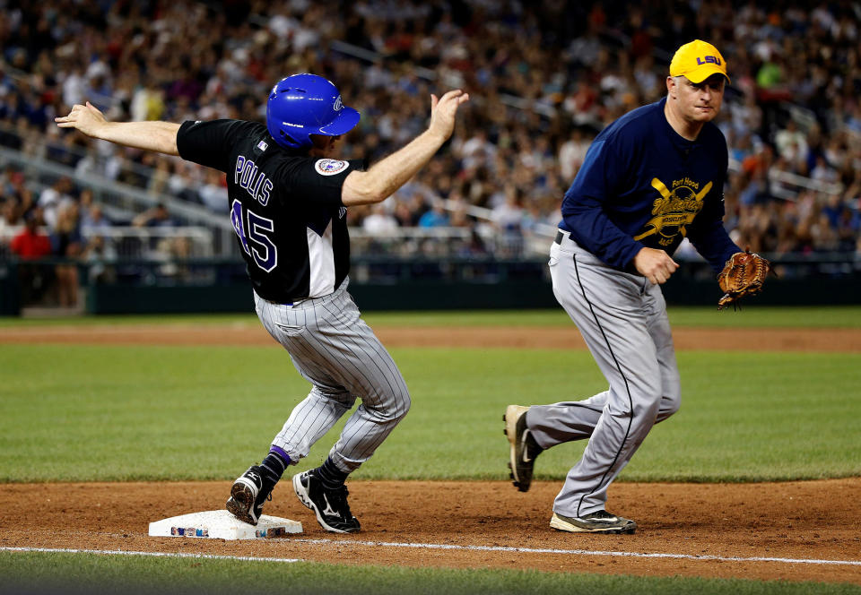 <p>Rep. Jared Polis (D-CO) trips over first base as Rep. Tom Rooney (R-FL) chases the ball during the annual Congressional Baseball Game at Nationals Park in Washington, June 15, 2017. (Photo: Joshua Roberts/Reuters) </p>