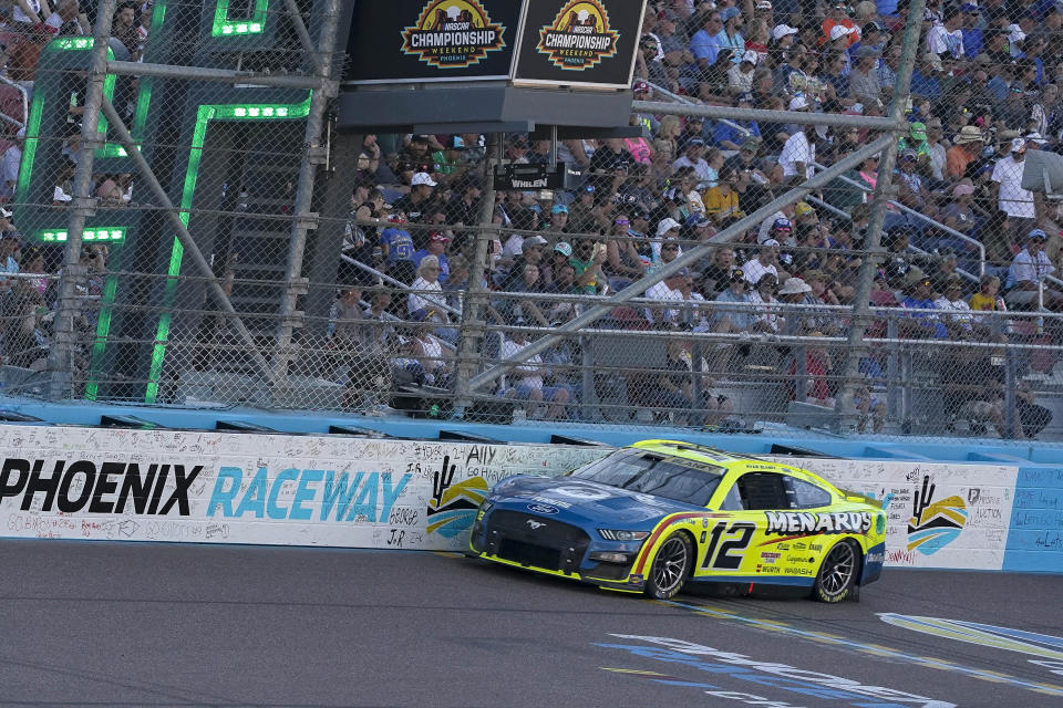 Ryan Blaney (12) drives down the frontstretch during a NASCAR Cup Series Championship auto race at Phoenix Raceway, Sunday, Nov. 5, 2023, in Avondale, Ariz. (AP Photo/Darryl Webb)