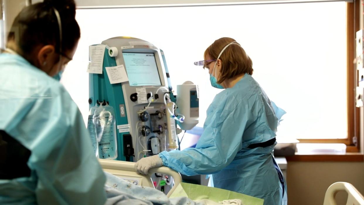 A health care professional monitors a COVID-19 patient at Sanford Hospital.