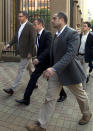Oscar Pistorius, center, accompanied by relatives arrive the high court for the murder trial of Pistorius in Pretoria, South Africa, Monday, March 17, 2014. Pistorius is charged with murder for the shooting death of his girlfriend, Reeva Steenkamp, on Valentines Day in 2013. (AP Photo/Themba Hadebe)