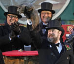 <p>Groundhog Club co-handler Al Dereume holds Punxsutawney Phil, the weather prognosticating groundhog, during the 132nd celebration of Groundhog Day on Gobbler’s Knob in Punxsutawney, Pa. Friday, Feb. 2, 2018. (Photo: Gene J. Puskar/AP) </p>