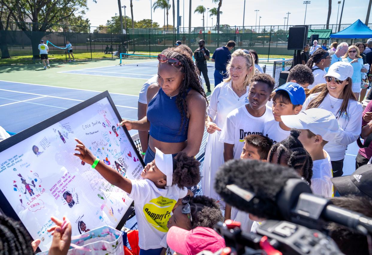 Coco Gauff gets a gift from children at a ceremony celebrating two refurbished public tennis courts at Pompey Park as part of USTA's US Open Legacy Initiative, which was created in celebration of Gauff's 2023 U.S. Open women's singles on March 19, 2024 in Delray Beach, Florida.