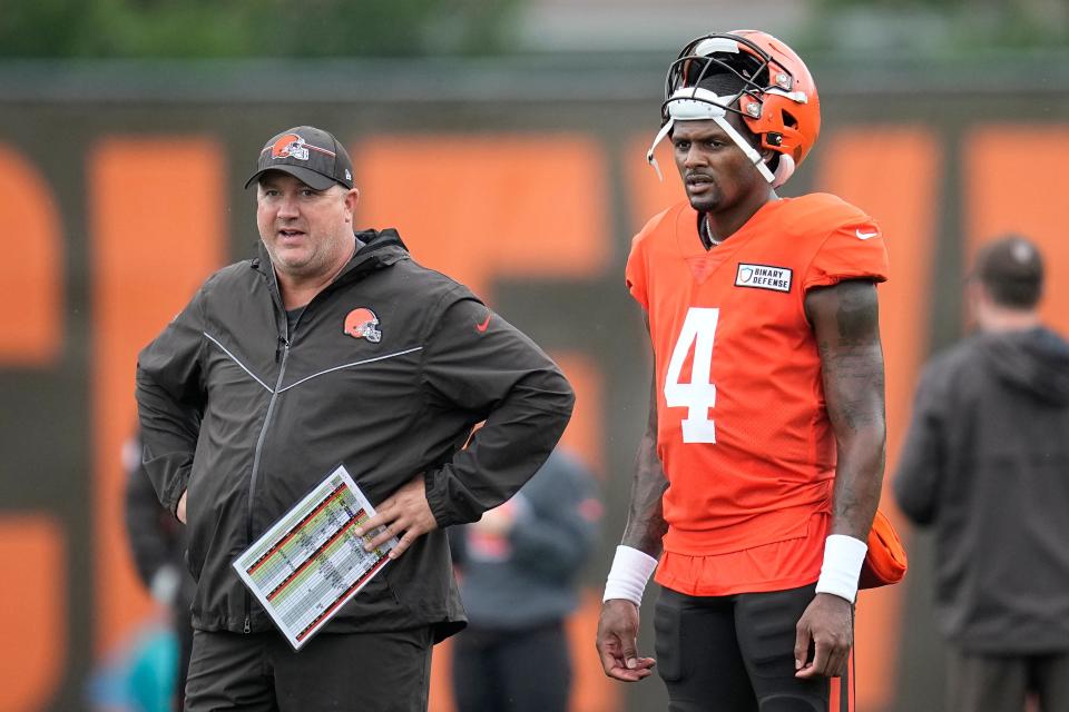 Cleveland Browns offensive coordinator Alex Van Pelt, left, and quarterback Deshaun Watson (4) watch during camp Aug. 7 in Berea.