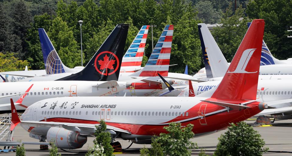 Dozens of grounded Boeing 737 MAX airplanes crowd a parking area adjacent to Boeing Field in Seattle.