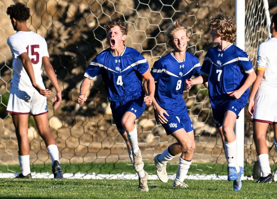 Gideon Drury (4) celebrates with his Upper Cape Tech teammates as he ties the game at 2 against Cape Tech.