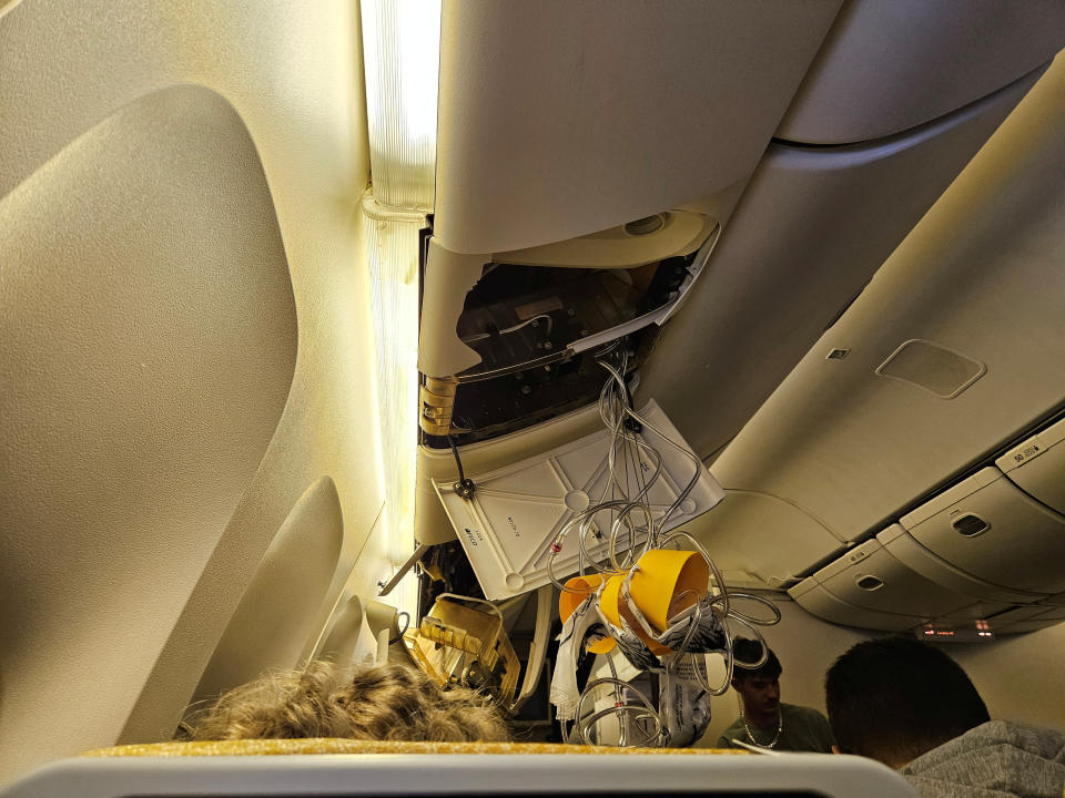 Material from the overhead locker hangs down towards passengers after the turbulence.  Obtained by Reuters/Handout via REUTERS    