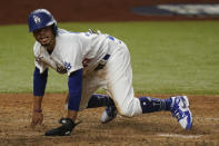 Los Angeles Dodgers' Mookie Betts scores on a fielders choice by Max Muncy during the fifth inning in Game 1 of the baseball World Series against the Tampa Bay Rays Tuesday, Oct. 20, 2020, in Arlington, Texas. (AP Photo/Eric Gay)