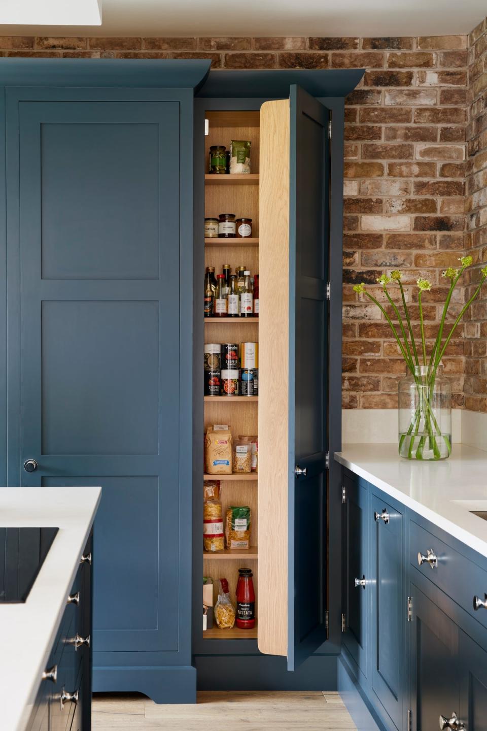 Consider offsetting dark coloured cabinets with glossy white worktops (Tom Howley)