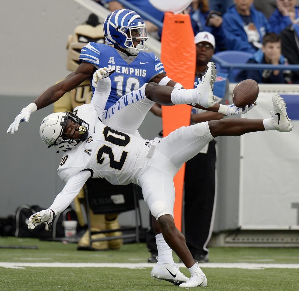 Central Florida defensive back Brandon Moore (20) breaks up a pass intended for Memphis wide receiver Damonte Coxie (10) during the first half of an NCAA college football game Saturday, Oct. 13, 2018, in Memphis, Tenn. (AP Photo/Mark Zaleski)