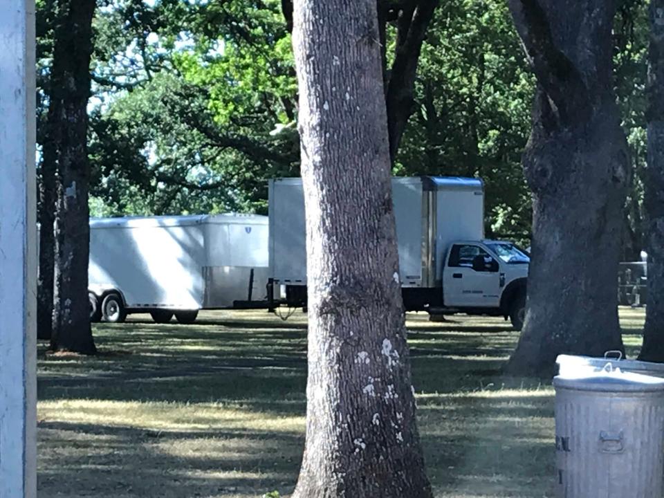 Vehicles drove and parked on tree roots in Bush's Pasture Park during the 2019 Salem Art Fair and Festival
