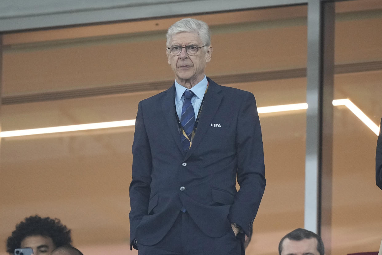 Former Arsenal coach Arsene Wenger stands on the tribune before the World Cup group G soccer match between Serbia and Switzerland, at the Stadium 974 in Doha, Qatar, Friday, Dec. 2, 2022. (AP Photo/Martin Meissner)