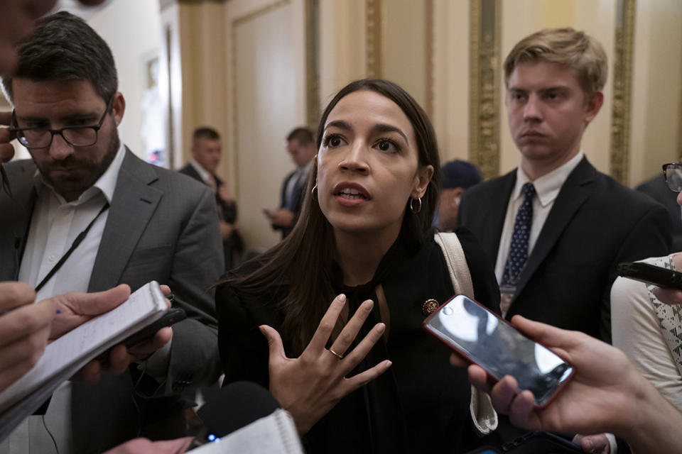 Rep. Alexandria Ocasio-Cortez, D-N.Y., a target of racist rhetoric from President Donald Trump, responds to reporters as she arrives for votes in the House, at the Capitol in Washington, Thursday, July 18, 2019. (AP Photo/J. Scott Applewhite)