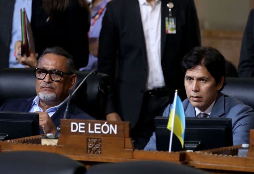 LOS ANGELES, CA - OCTOBER 11: Councilmember District 1 - Gil Cedillo, left, and Councilmember District 14 - Kevin de Leon, right, at the Los Angeles City Council meeting at Los Angeles City Hall on Tuesday, Oct. 11, 2022 in Los Angeles, CA. Protestors want the resignation of Los Angeles Councilmembers Nury Martinez, Kevin de Leon and Gil Cedillo. Martinez made racist remarks about Councilmember Mike Bonin son in the recording as her colleagues, Councilmembers Kevin de Leon and Gill Cedillo, laughed and made wisecracks. (Gary Coronado / Los Angeles Times)