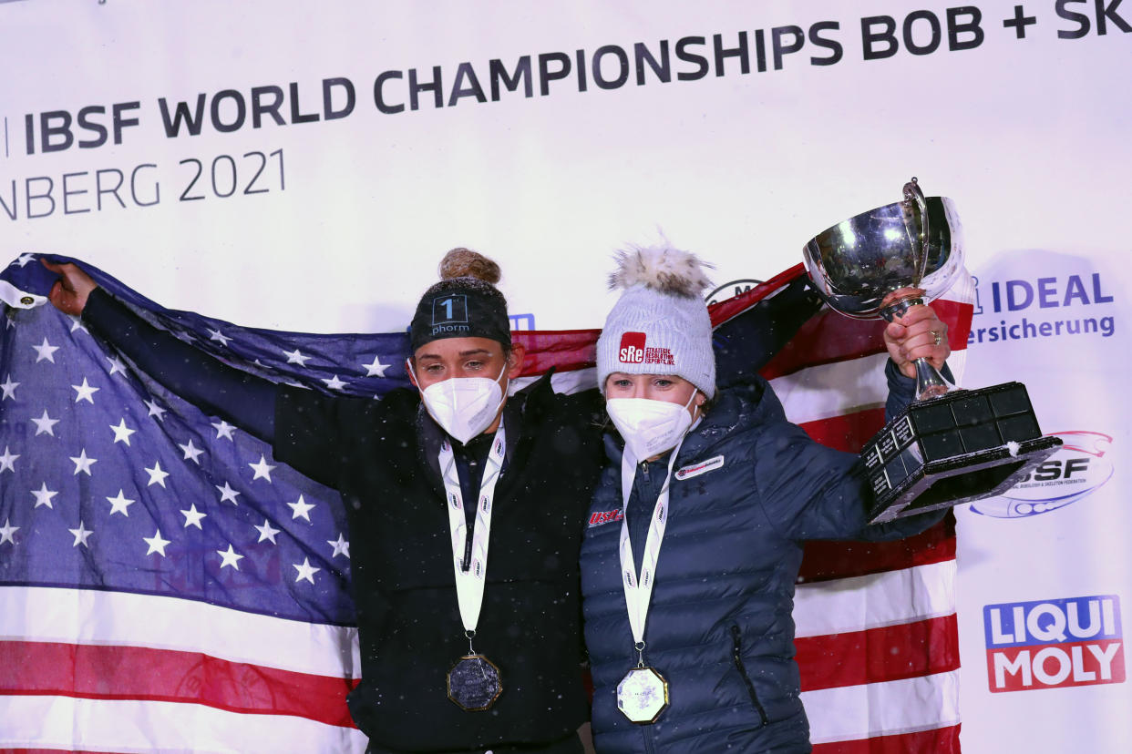 Kaillie Humphries, right, and Lolo Jones of the United States celebrate after winning the two women's bobsleigh race at the Bobsleigh and Skeleton World Championships in Altenberg, Germany, Saturday, Feb. 6, 2021. (AP Photo/Matthias Schrader)