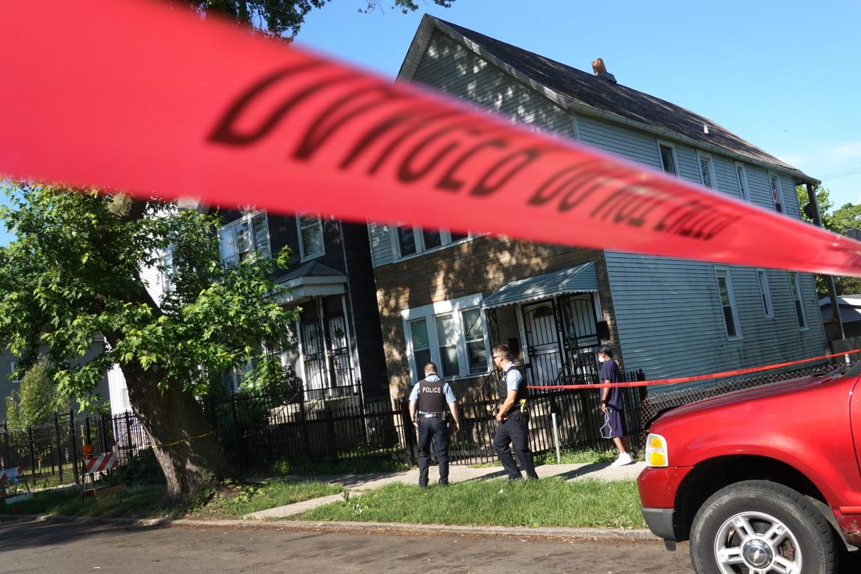 Police secure the scene of a shooting on June 15, 2021 in the Englewood neighborhood of Chicago, Illinois. Four people were killed at a home during an early-morning shooting and four others who were injured were transported to the hospital.