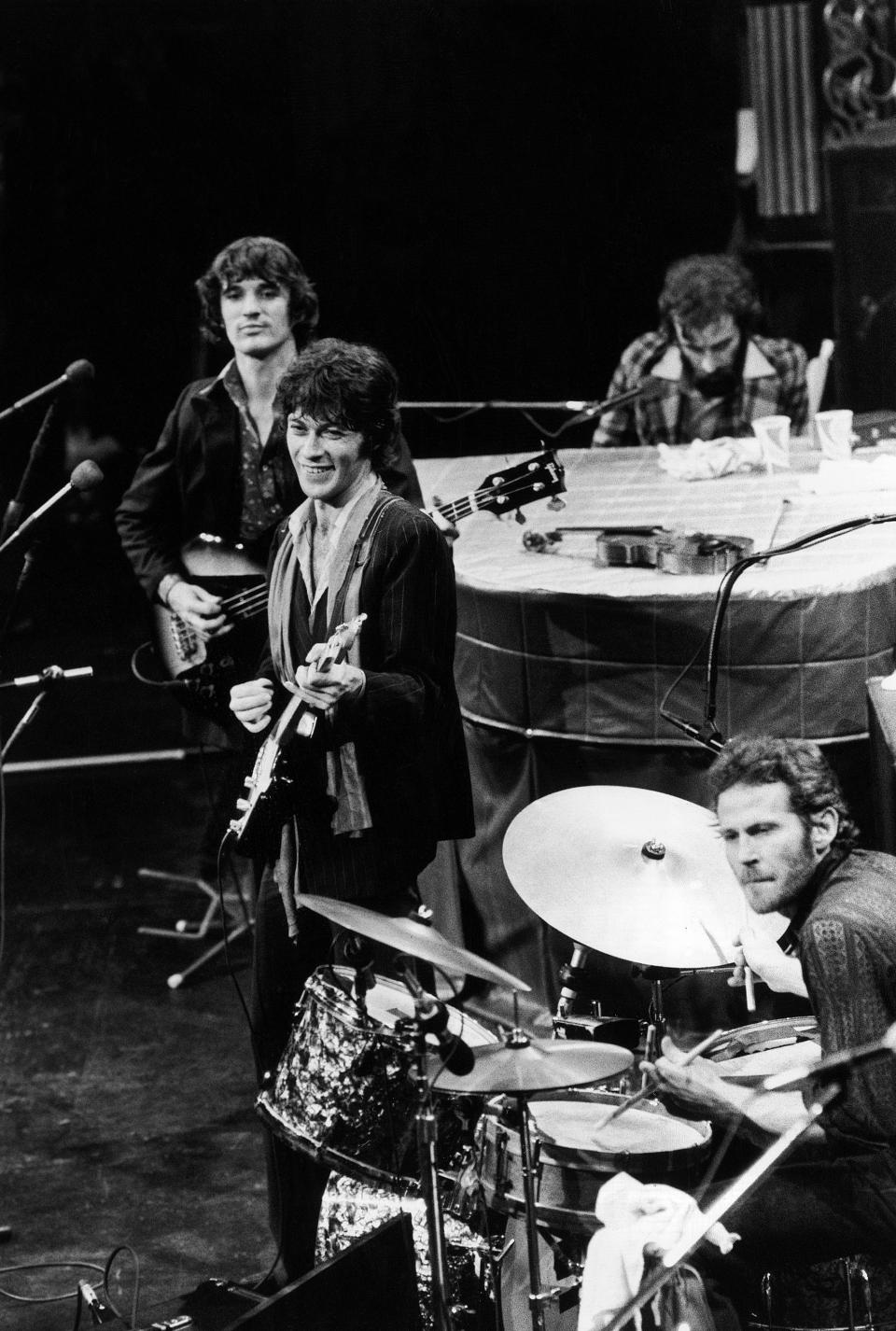 FILE - In this Nov. 27, 1976 file photo, The Band, Richard Manuel on piano, Levon Helm on drums, lead guitarist Robbie Robertson, center, and bass guitarist Rick Danko, take the stage for their final live performance before a crowd of 5,000 at Winterland Auditorium in San Francisco. Roberston, 76, said in a recent interview that he was in a melancholy mood when he wrote the song, "“Once Were Brothers," already looking backward on his life while he was helping create a new documentary on The Band. (AP Photo/John Storey, file)