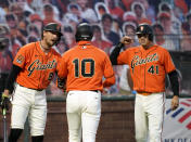 San Francisco Giants' Evan Longoria (10) is congratulated by teammates Hunter Pence (8) and Wilmer Flores (41) after hitting a two-run home run against the Arizona Diamondbacks during the third inning of a baseball game in San Francisco, Friday, Aug. 21, 2020. (AP Photo/Tony Avelar)