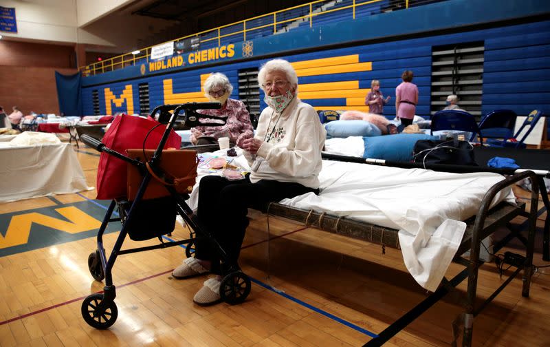 Dot Costello, 101 years old, sits on a bed at an evacuee centre after being evacuated from her home along the Tittabawassee River, after several dams breached, in Midland