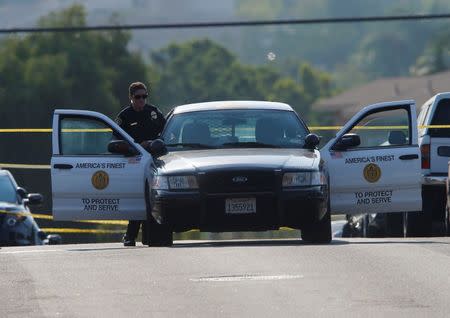 San Diego police officers investigate near the scene where an officer was fatally shot and another was injured at a traffic stop late on Thursday, in San Diego, California, U.S., July 29, 2016. REUTERS/Mike Blake