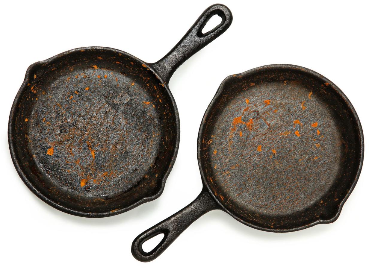 set of two rusty cast iron skillets