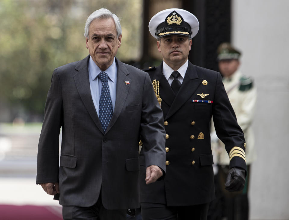 Chile's President Sebastian Pinera arrives to La Moneda presidential palace in Santiago, Chile, Monday, Nov. 18, 2019. The main political parties in the country agreed Friday to call for a new constitution to replace one imposed by a military dictatorship almost 40 years ago, a move that follows a month of turbulent social protests in the streets. (AP Photo/Esteban Felix)