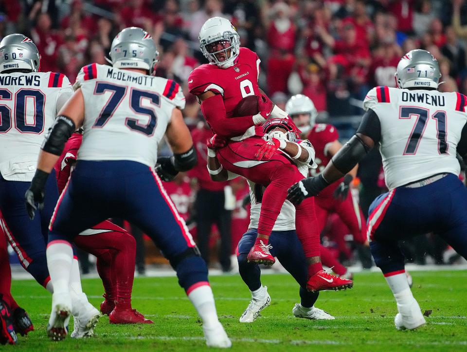 Cardinals linebacker Isaiah Simmons (9) runs after an interception against the Patriots during the first half of a game at State Farm Stadium in Glendale on Dec. 12, 2022.