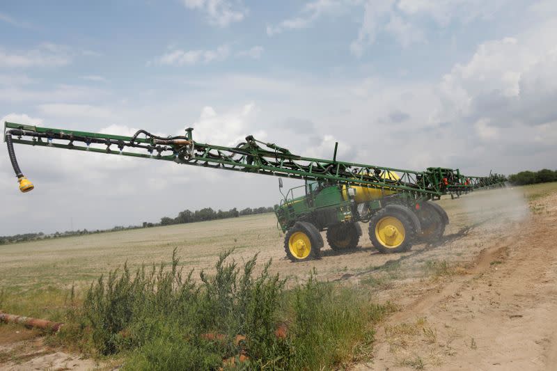 FILE PHOTO: A fertilising vehicle makes its way across crops outside Gideon, Missouri