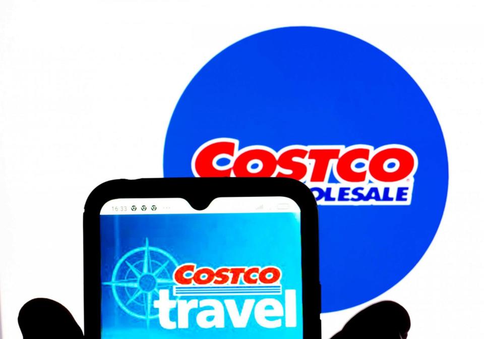 PHOTO: The Costco Travel logo is displayed on a smartphone screen with a Costco Wholesale Corporation logo in the background. (Illustration/LightRocket via Getty Images)