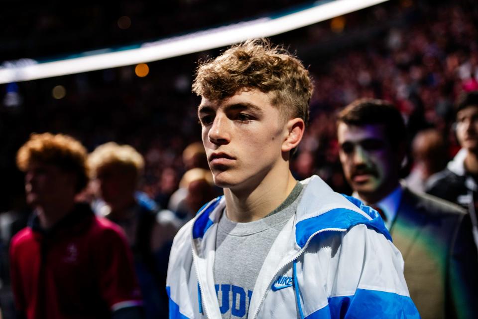 Poudre High School boys wrestler Billy Greenwood walks in the parade of champions before the finals at the Colorado state wrestling tournament at Ball Arena in Denver, Colo., on Saturday, Feb. 17, 2024.