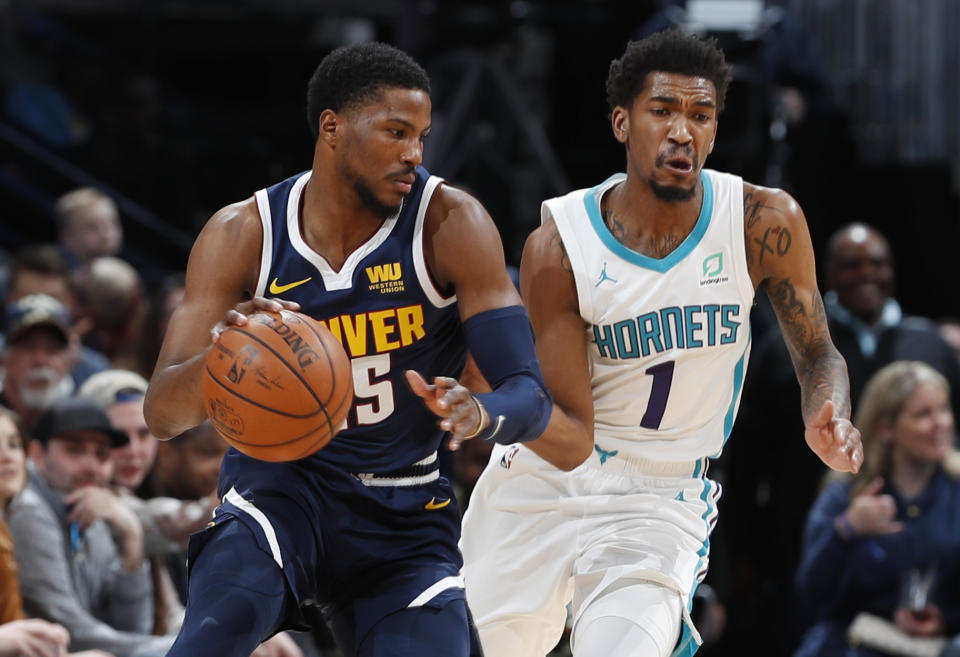 Denver Nuggets guard Malik Beasley, left, drives past Charlotte Hornets guard Malik Monk in the first quarter of an NBA basketball game Saturday, Jan. 5, 2019, in Denver. (AP Photo/David Zalubowski)