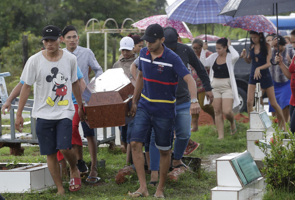 Relatives carry the coffin that contain the remains of 25-year-old William de Souza, an inmate who was killed in the recent prison riots, to a burial site in Manaus, Brazil, Thursday, May 30, 2019. Families were burying victims of several prison riots in which dozens of inmates died in the northern Brazilian state of Amazonas, as authorities confirmed they had received warnings of an “imminent confrontation” days before the attacks begun. (AP Photo/Andre Penner)