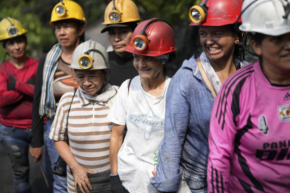 Emerald miners line uo to enter the tunnels of an informal mine near the town of Coscuez, Colombia, Thursday, Feb. 29, 2024. After they enter in a single file, they branch off in different directions and head into tunnels where each person has a designated area to drill. (AP Photo/Fernando Vergara)