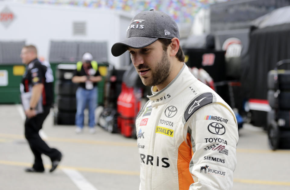 Daniel Suarez walks from the garage after practice for the NASCAR Daytona 500 auto race at Daytona International Speedway in Daytona Beach, Fla., Friday, Feb. 16, 2018. (AP Photo/Terry Renna)