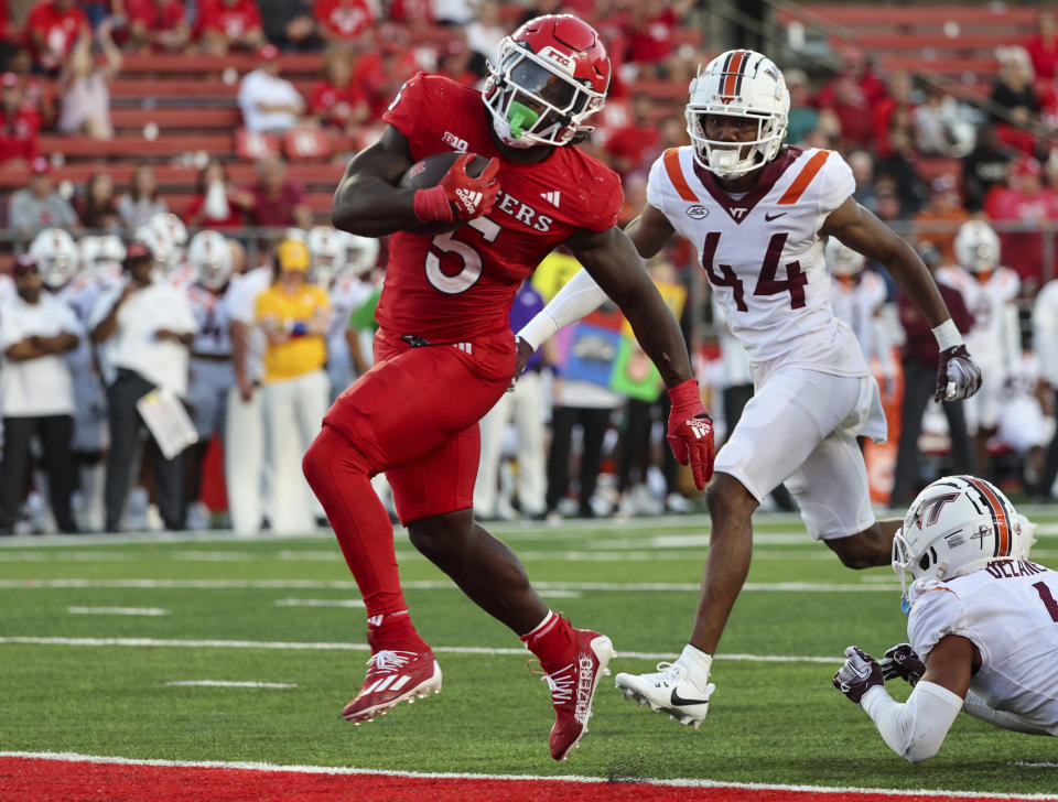 Rutgers running back Kyle Monangai (5) avoids Virginia Tech cornerback Mansoor Delane (4) to score his a touchdown in the fourth quarter of an NCAA college football game against Rutgers, Saturday, Sept. 16, 2023, in Piscataway, N.J. (Andrew Mills/NJ Advance Media via AP)