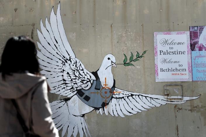 Street art by Banksy shows a dove with a bulletproof vest near his hotel in the occupied West Bank town of Bethlehem (AFP Photo/THOMAS COEX)