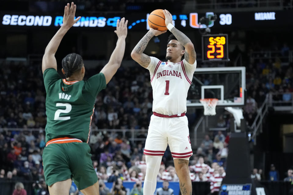 Indiana's Jalen Hood-Schifino (1) shoots over Miami's Isaiah Wong (2) in the first half of a second-round college basketball game in the NCAA Tournament, Sunday, March 19, 2023, in Albany, N.Y. (AP Photo/John Minchillo)