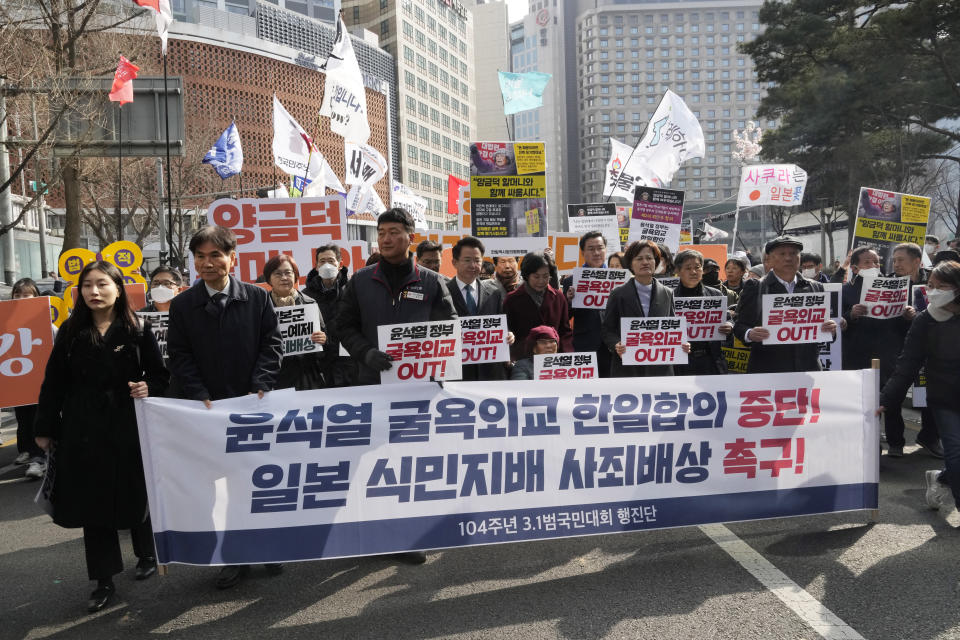 Protesters march toward the Japanese Embassy during a rally against the South Korean government's move to improve relations with Japan in Seoul, South Korea, Wednesday, March 1, 2023. South Korea's president on Wednesday called Japan "a partner that shares the same universal values" and renewed hopes to repair ties frayed over Japan's colonial rule of the Korean Peninsula. The banner reads "Suspend South Korean President Yoon Suk Yeol's South Korea-Japan agreement." (AP Photo/Ahn Young-joon)