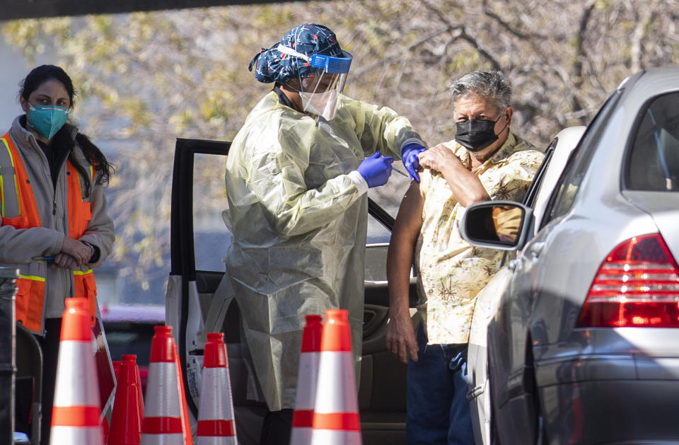 A nurse gives a Covid-19 vaccine shot to a patient at CSUN Covid-19 vaccination center in Northridge, California on February 2, 2021. (Photo by VALERIE MACON / AFP) (Photo by VALERIE MACON/AFP via Getty Images)