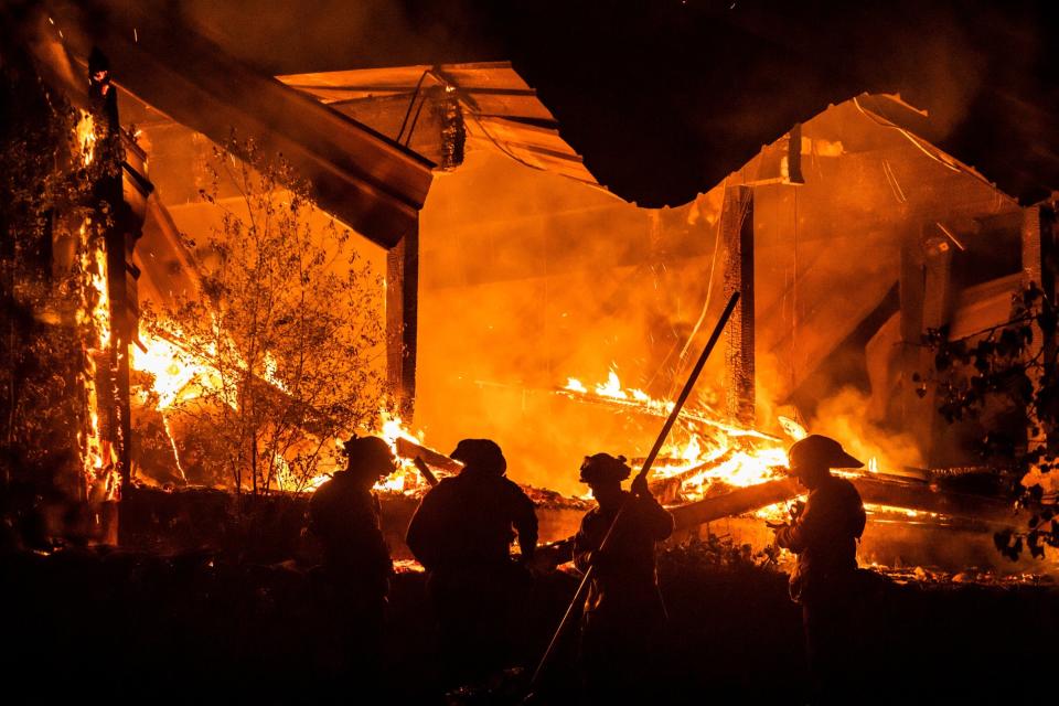 Firefighters tend to a structure lost during the Kincade fire in Healdsburg on Tuesday night.&nbsp; (Photo: PHILIP PACHECO via Getty Images)