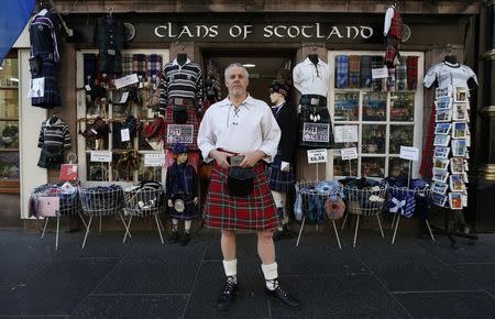 Souvenir merchant Steve Wright poses outside his shop, Clans of Scotland, in Edinburgh, Scotland April 29, 2014. REUTERS/Suzanne Plunkett