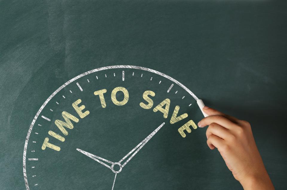 Clock drawn on chalkboard with the words time to save along the top.