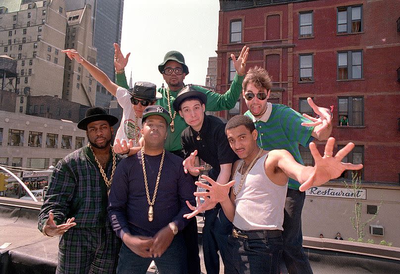 Run-DMC and the Beastie Boys pose atop a restaurant in midtown Manhattan on Monday, May 11, 1987.