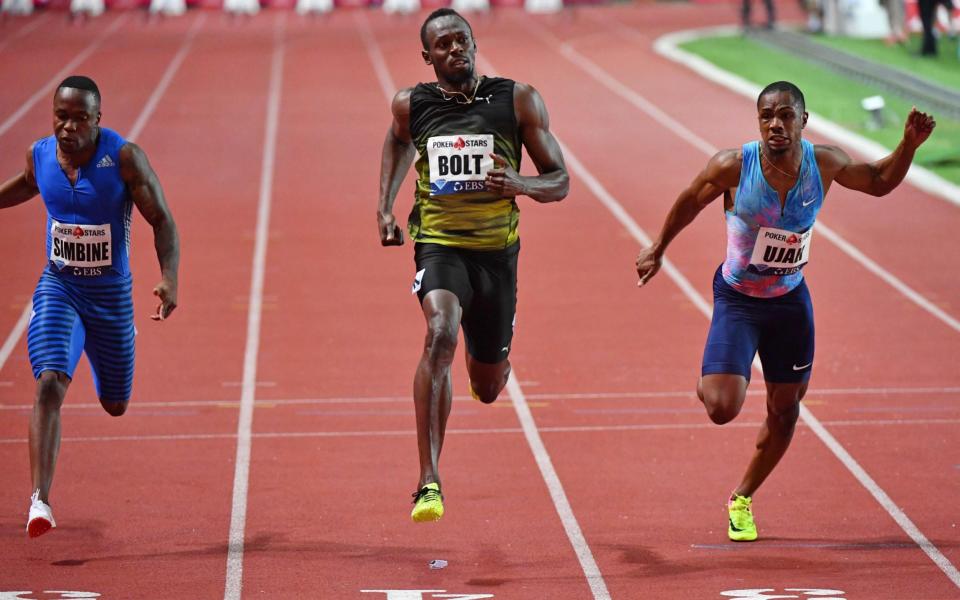 Jamaica's Usain Bolt (C) crosses the finish line to win the men's 100m event at the IAAF Diamond League athletics - Credit: AFP/Getty Images