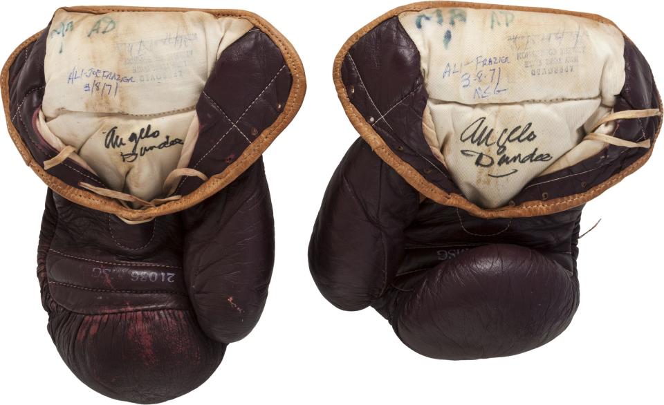 The 1971 Muhammad Ali gloves from his first Joe Frazier bout are pictured in this undated handout photo courtesy of Heritage Auctions received July 31, 2014. The gloves that boxing legend Muhammad Ali wore in his legendary 1971 fight against Joe Frazier in what became known as the Fight of the Century will come up for auction on Thursday and are expected to fetch more than $300,000. REUTERS/Heritage Auctions/Handout via Reuters (UNITED - Tags: ENTERTAINMENT SPORT BOXING) ATTENTION EDITORS - NO SALES. NO ARCHIVES. FOR EDITORIAL USE ONLY. NOT FOR SALE FOR MARKETING OR ADVERTISING CAMPAIGNS. THIS PICTURE WAS PROVIDED BY A THIRD PARTY. REUTERS IS UNABLE TO INDEPENDENTLY VERIFY THE AUTHENTICITY, CONTENT, LOCATION OR DATE OF THIS IMAGE. THIS PICTURE IS DISTRIBUTED EXACTLY AS RECEIVED BY REUTERS, AS A SERVICE TO CLIENTS