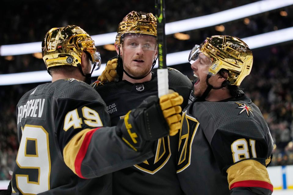Vegas Golden Knights celebrate after center Jack Eichel, center, scored against the Columbus Blue Jackets during the second period of an NHL hockey game Sunday, March 19, 2023, in Las Vegas. (AP Photo/John Locher)