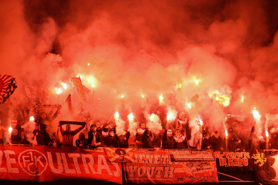 Kaiserslautern's fans light fireworks during the German soccer cup (DFB Pokal) semifinal match between FC Bayern Munich and FC Kaiserslautern in the Allianz Arena in Munich, Germany, on Wednesday, April 16. 2014. (AP Photo/Kerstin Joensson)