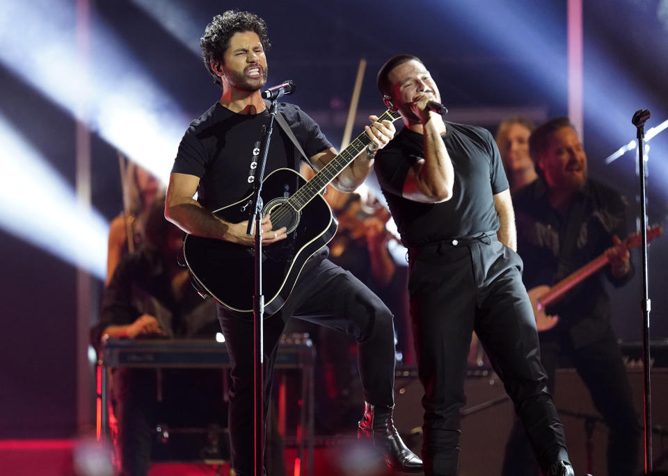 Dan Smyers, left, and Shay Mooney of Dan + Shay perform "Save Me The Trouble"at the 57th Annual CMA Awards on Wednesday, Nov. 8, 2023, at the Bridgestone Arena in Nashville, Tenn. (AP Photo/George Walker IV)