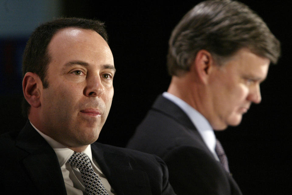 FILE- In this Nov. 17, 2004, file photo Kmart chairman Edward Lampert, left, and Sears CEO Alan Lacy listen during a news conference to announce the merger of Kmart and Sears in New York. A bankruptcy judge has blessed a $5.2 billion plan by Sears chairman and biggest shareholder Lampert to keep the iconic business going. The approval means roughly 425 stores and 45,000 jobs will be preserved. (AP Photo/Gregory Bull, File)