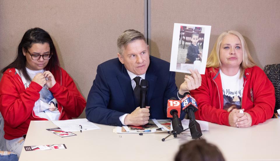 Bobby DiCello, holding a photo of one of Zach Fornash's children, talked Thursday about how the children will never see their father again during a press conference Thursday at the Stark Community Support Network in Canton. Family members and friends are also gathered at the table. To his left is Zach Fornash's wife, Alexus, and to his right Fornash's mother, Cassandra White.