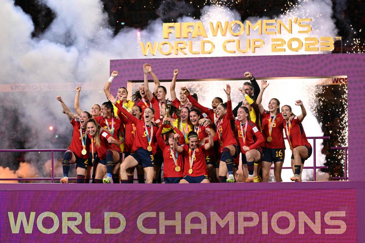 Spain's players celebrate with the trophy after winning the Australia and New Zealand 2023 Women's World Cup final football match between Spain and England at Stadium Australia in Sydney on August 20, 2023. (Photo by WILLIAM WEST / AFP) (Photo by WILLIAM WEST/AFP via Getty Images)